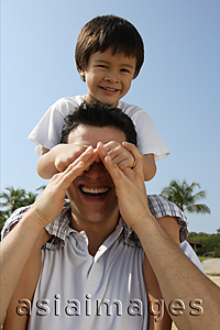 Asia Images Group - Father carrying son on his shoulders st the beach