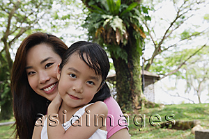 Asia Images Group - Mother and daughter at the park, both looking at camera