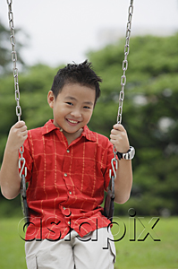 AsiaPix - Boy on swing, smiling at camera