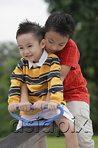 AsiaPix - Two brothers sitting on See-Saw