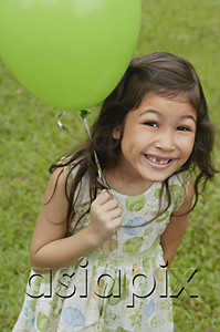 AsiaPix - Girl holding green balloon, smiling at camera