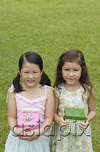 AsiaPix - Two girls with gift boxes, standing side by side, smiling at camera