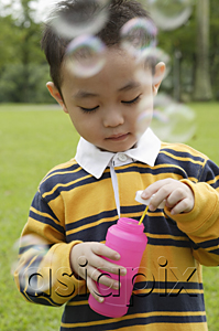 AsiaPix - Boy with bubble wand, bubbles around him