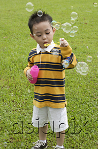 AsiaPix - Boy blowing bubbles from bubble wand