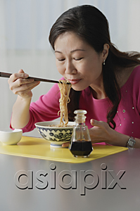 AsiaPix - Mature woman eating a bowl of noodles, eyes closed