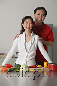 AsiaPix - Mature couple in kitchen, smiling at camera