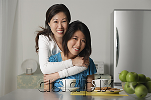 AsiaPix - Mother embracing adult daughter, both smiling at camera