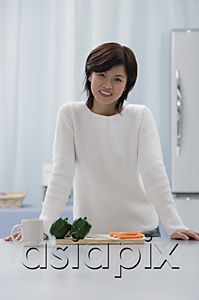AsiaPix - Woman in kitchen, smiling at camera