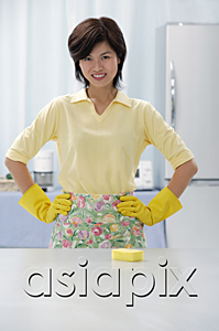 AsiaPix - Woman in kitchen, wearing gloves and apron, hands on hips