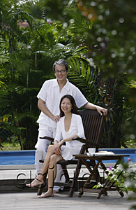 AsiaPix - Couple outdoors by swimming pool, looking at camera, portrait