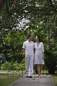 AsiaPix - Couple walking along path in garden, looking at each other