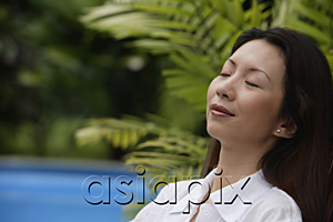 AsiaPix - Woman outdoors, eyes closed, head shot