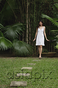 AsiaPix - Woman in garden, walking on stepping stones