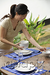 AsiaPix - Woman setting the table