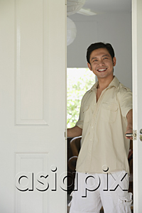 AsiaPix - Man at home, standing at doorway, smiling