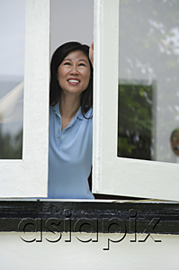 AsiaPix - Woman opening windows, smiling