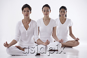 AsiaPix - three women sitting in yoga posture OM, meditating, eyes closed