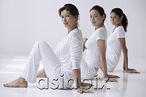 AsiaPix - three women sitting on floor, side view, looking at camera