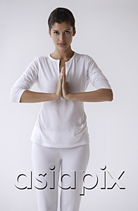 AsiaPix - Woman standing with hands in namaste, prayer, looking at camera