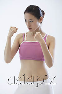 AsiaPix - Woman standing in fighting stance, boxing