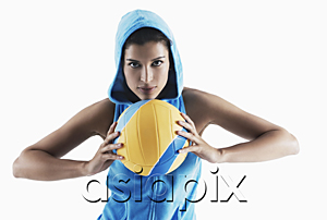 AsiaPix - Woman holding volleyball, looking at camera