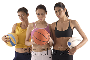 AsiaPix - three women of different race, holding volleyball, basketball, and rugby ball, looking at camera