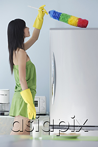 AsiaPix - woman in kitchen, dusting, cleaning, top of fridge