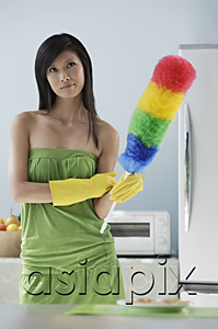 AsiaPix - woman in kitchen, holding feather duster, thinking, cleaning