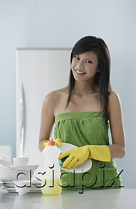 AsiaPix - woman in kitchen, washing dishes, smiling at camera