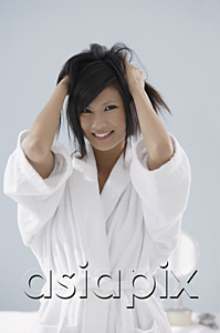 AsiaPix - woman wearing bathrobe and running hands through hair, smiling