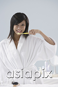 AsiaPix - woman wearing bathrobe, brushing teeth in bathroom
