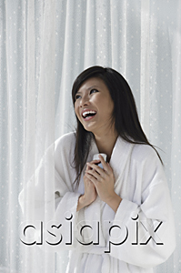 AsiaPix - woman in bathrobe, holding phone to chest and laughing