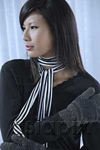 AsiaPix - woman wearing scarf and mittens, looking away from camera