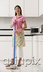 AsiaPix - Woman with mop in kitchen, cleaning, looking at camera, smiling