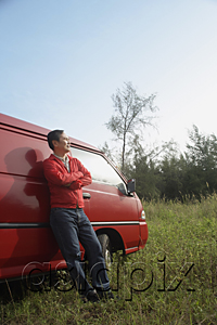 AsiaPix - Man leaning against red van, outdoors in nature