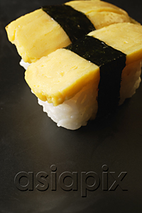 AsiaPix - Two pieces of sushi, Tam ago Nigeria, sweet Japanese egg omelettes on sushi rice ball