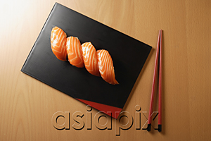 AsiaPix - four pieces of salmon sushi, nigiri on rice ball, chopsticks