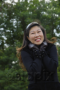 AsiaPix - Mature woman wearing leather gloves and smiling at camera, cold