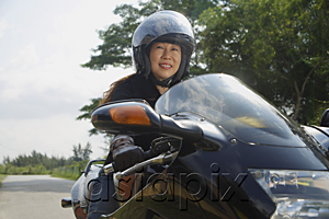 AsiaPix - Mature woman riding motorcycle and wearing helmet