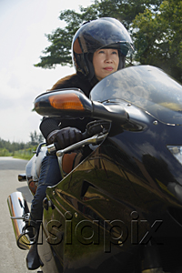 AsiaPix - Mature woman riding motorcycle, wearing helmet