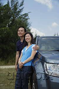 AsiaPix - Man and woman leaning against SUV, arm around woman