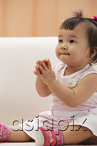 AsiaPix - Baby Girl sitting and holding hands in prayer