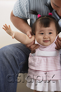 AsiaPix - father and baby girl, father holding girl under arms