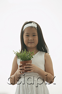 AsiaPix - young girl holding plant, smiling, looking at camera