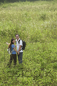 AsiaPix - Man and woman hiking in nature, outdoors, looking at camera