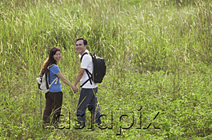 AsiaPix - Man and woman hiking through tall grass, nature, outdoors
