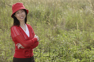 AsiaPix - woman standing outdoors in nature, smiling at camera