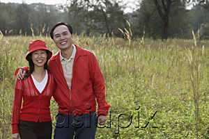 AsiaPix - Man and woman standing outdoors in nature, smiling at camera, portrait