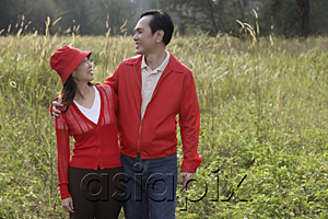 AsiaPix - Man and woman standing outdoors in nature, smiling at each other