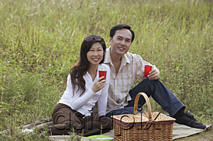 AsiaPix - Man and woman having picnic outdoors in nature